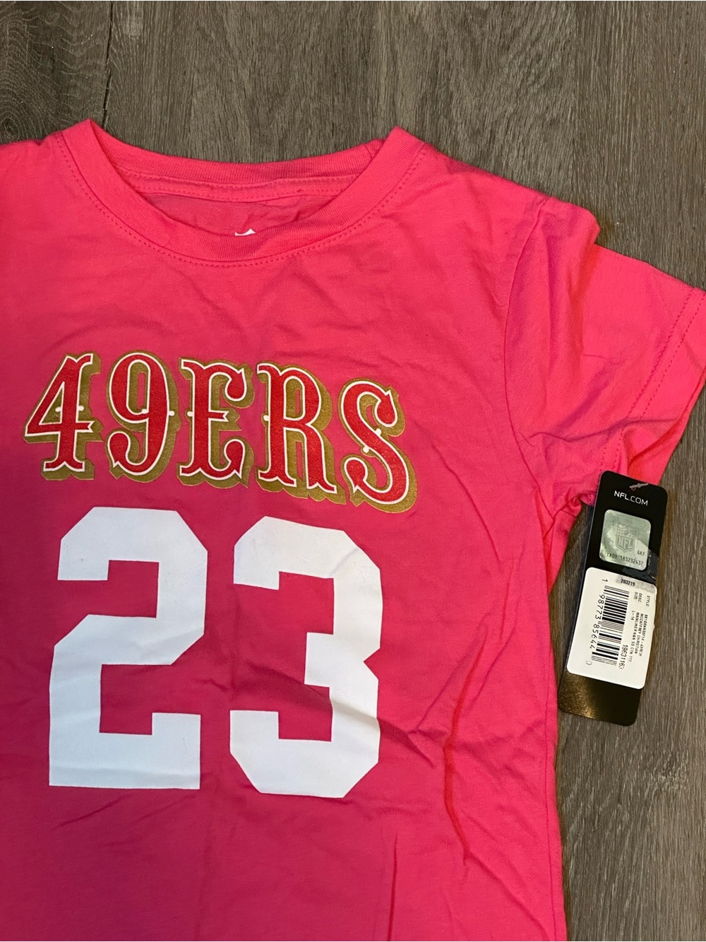 NFL | Girl’s Pink 49ers McCaffrey #23 Short Sleeve Tee | Size L/14 - NWT!
